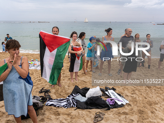 Dozens of activists participate in the international initiative ''Swim With Gaza'' on Nova Icaria beach, in Barcelona, Spain, on September 1...