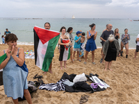 Dozens of activists participate in the international initiative ''Swim With Gaza'' on Nova Icaria beach, in Barcelona, Spain, on September 1...