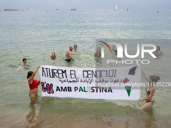 Dozens of activists participate in the international initiative ''Swim With Gaza'' on Nova Icaria beach, in Barcelona, Spain, on September 1...