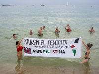 Dozens of activists participate in the international initiative ''Swim With Gaza'' on Nova Icaria beach, in Barcelona, Spain, on September 1...