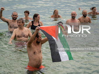 Dozens of activists participate in the international initiative ''Swim With Gaza'' on Nova Icaria beach, in Barcelona, Spain, on September 1...