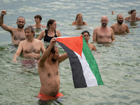 Dozens of activists participate in the international initiative ''Swim With Gaza'' on Nova Icaria beach, in Barcelona, Spain, on September 1...