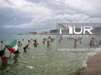 Dozens of activists participate in the international initiative ''Swim With Gaza'' on Nova Icaria beach, in Barcelona, Spain, on September 1...