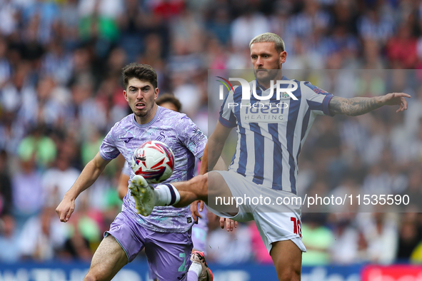 John Swift of West Bromwich (R) and Joshua Key of Swansea are in action during the Sky Bet Championship match between West Bromwich Albion a...