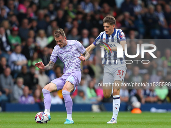 Josh Tymon of Swansea (L) and Tom Fellows of West Bromwich compete during the Sky Bet Championship match between West Bromwich Albion and Sw...