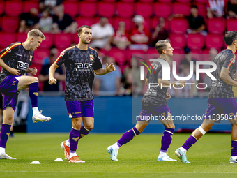 The Go Ahead Eagles warm up during the match PSV vs. Go Ahead Eagles at the Philips Stadium for the Dutch Eredivisie 4th round season 2024-2...