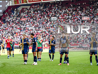 Players of FC Twente are disappointed after the match. FC Twente player Sem Steijn, FC Twente player Daan Rots, and FC Twente player Mees Hi...