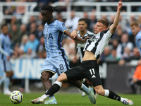 Tottenham Hotspur's Yves Bissouma is challenged by Newcastle United's Harvey Barnes during the Premier League match between Newcastle United...