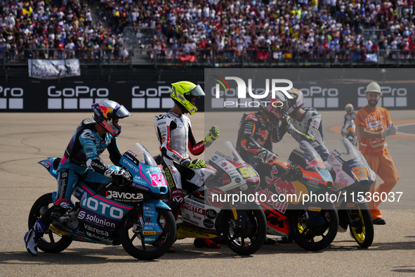 David Alonso (80) of Colombia and CFMoto Gaviota Aspar Team, Luca Lunetta (58) of Italy and Sic58 Squadra Corse Honda, Jose Antonio Rueda (9...