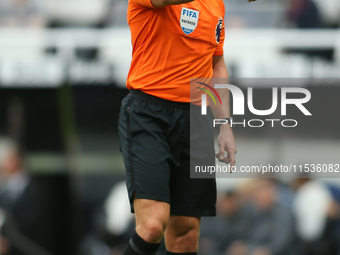 Referee Robert Jones officiates the Premier League match between Newcastle United and Tottenham Hotspur at St. James's Park in Newcastle, En...