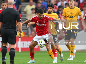 Morgan Gibbs-White of Nottingham Forest holds off Goncalo Guedes of Wolverhampton Wanderers during the Premier League match between Nottingh...