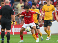 Morgan Gibbs-White of Nottingham Forest holds off Goncalo Guedes of Wolverhampton Wanderers during the Premier League match between Nottingh...