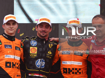 Oscar Piastri of McLaren, Charles Leclerc of Ferrari and Lando Norris of McLaren after the Formula 1 Italian Grand Prix at Autodromo Naziona...