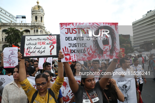 Citizens take part in a protest rally against the rape and murder of a PGT woman doctor at Government-run R G Kar Medical College & Hospital...