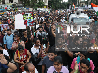 Citizens take part in a protest rally against the rape and murder of a PGT woman doctor at Government-run R G Kar Medical College & Hospital...