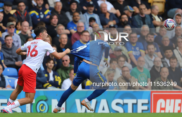 Mackenzie Hunt of Fleetwood Town pulls Wimbledon's Joe Pigott's shirt during the Sky Bet League 2 match between AFC Wimbledon and Fleetwood...