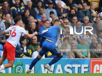 Mackenzie Hunt of Fleetwood Town pulls Wimbledon's Joe Pigott's shirt during the Sky Bet League 2 match between AFC Wimbledon and Fleetwood...