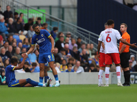 Omar Bugiel helps Alistair Smith up after a bad tackle during the Sky Bet League 2 match between AFC Wimbledon and Fleetwood Town at Plough...