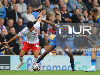 Phoenix Peterson of Fleetwood battles with Wimbledon's Josh Neufville during the Sky Bet League 2 match between AFC Wimbledon and Fleetwood...