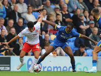 Phoenix Peterson of Fleetwood battles with Wimbledon's Josh Neufville during the Sky Bet League 2 match between AFC Wimbledon and Fleetwood...