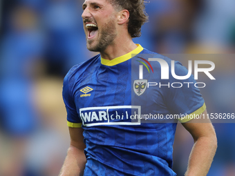 AFC Wimbledon player Joe Lewis celebrates with the fans after the Sky Bet League 2 match between AFC Wimbledon and Fleetwood Town at Plough...