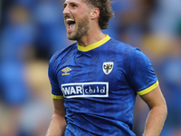 AFC Wimbledon player Joe Lewis celebrates with the fans after the Sky Bet League 2 match between AFC Wimbledon and Fleetwood Town at Plough...