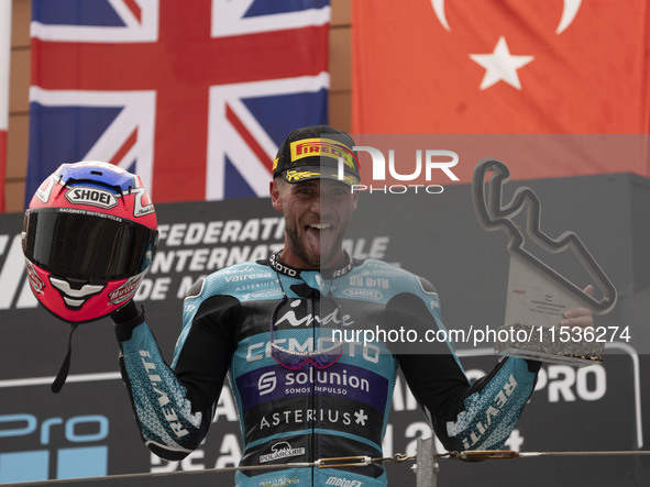 Jake Dixon stands on the winner's podium for the Moto2 category, representing the CFMOTO Inde Aspar Team on a KALEX bike, during the Moto Gr...