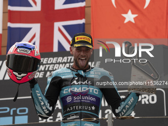 Jake Dixon stands on the winner's podium for the Moto2 category, representing the CFMOTO Inde Aspar Team on a KALEX bike, during the Moto Gr...