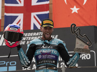 Jake Dixon stands on the winner's podium for the Moto2 category, representing the CFMOTO Inde Aspar Team on a KALEX bike, during the Moto Gr...