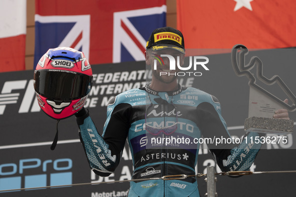 Jake Dixon stands on the winner's podium for the Moto2 category, representing the CFMOTO Inde Aspar Team on a KALEX bike, during the Moto Gr...