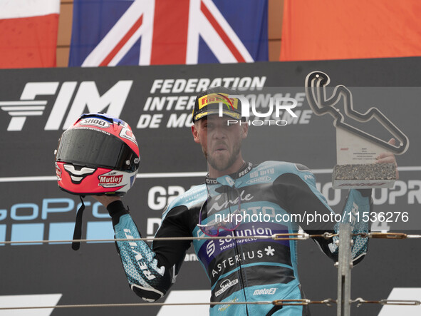 Jake Dixon stands on the winner's podium for the Moto2 category, representing the CFMOTO Inde Aspar Team on a KALEX bike, during the Moto Gr...