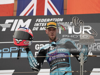 Jake Dixon stands on the winner's podium for the Moto2 category, representing the CFMOTO Inde Aspar Team on a KALEX bike, during the Moto Gr...