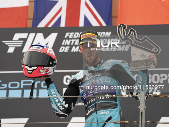 Jake Dixon stands on the winner's podium for the Moto2 category, representing the CFMOTO Inde Aspar Team on a KALEX bike, during the Moto Gr...