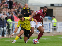 Burton Albion's Tomas Kalinauskas is challenged by Northampton Town's Ali Koiki during the first half of the Sky Bet League 1 match between...