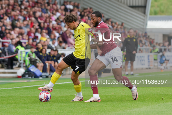 Burton Albion's Tomas Kalinauskas is challenged by Northampton Town's Ali Koiki during the first half of the Sky Bet League 1 match between...