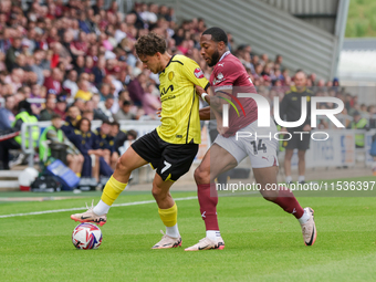 Burton Albion's Tomas Kalinauskas is challenged by Northampton Town's Ali Koiki during the first half of the Sky Bet League 1 match between...