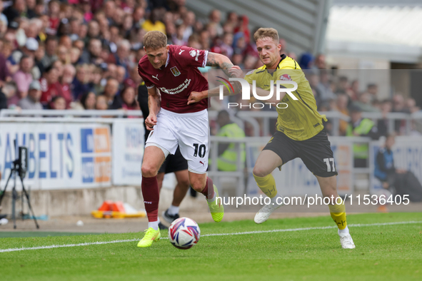 Mitch Pinnock of Northampton Town is challenged by Jack Armer of Burton Albion during the second half of the Sky Bet League 1 match between...