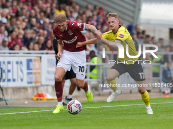 Mitch Pinnock of Northampton Town is challenged by Jack Armer of Burton Albion during the second half of the Sky Bet League 1 match between...