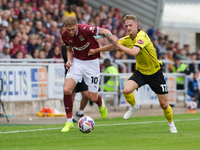 Mitch Pinnock of Northampton Town is challenged by Jack Armer of Burton Albion during the second half of the Sky Bet League 1 match between...