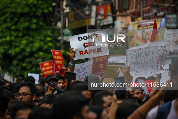 Students and citizens hold various posters during a rally in Kolkata, India, on September 1, 2024, demanding punishment for the accused invo...