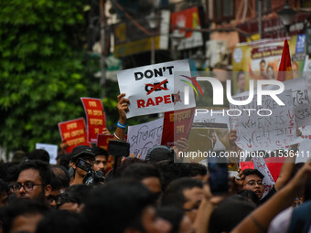 Students and citizens hold various posters during a rally in Kolkata, India, on September 1, 2024, demanding punishment for the accused invo...