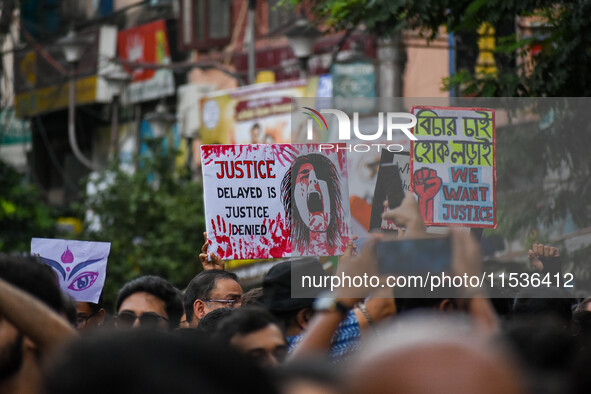 Students and citizens hold various posters during a rally in Kolkata, India, on September 1, 2024, demanding punishment for the accused invo...