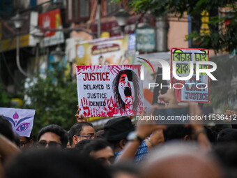 Students and citizens hold various posters during a rally in Kolkata, India, on September 1, 2024, demanding punishment for the accused invo...