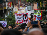 Students and citizens hold various posters during a rally in Kolkata, India, on September 1, 2024, demanding punishment for the accused invo...