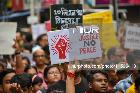 Students and citizens hold various posters during a rally in Kolkata, India, on September 1, 2024, demanding punishment for the accused invo...