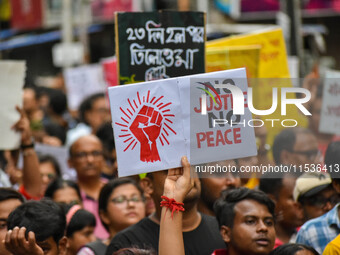 Students and citizens hold various posters during a rally in Kolkata, India, on September 1, 2024, demanding punishment for the accused invo...