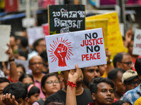 Students and citizens hold various posters during a rally in Kolkata, India, on September 1, 2024, demanding punishment for the accused invo...