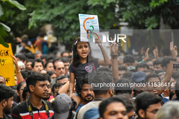 Students and citizens hold various posters during a rally in Kolkata, India, on September 1, 2024, demanding punishment for the accused invo...