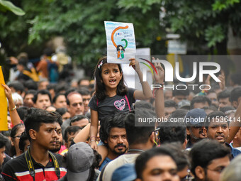 Students and citizens hold various posters during a rally in Kolkata, India, on September 1, 2024, demanding punishment for the accused invo...