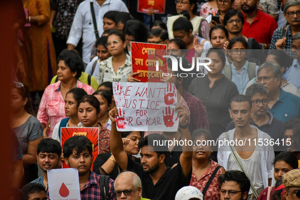 Students and citizens hold various posters during a rally in Kolkata, India, on September 1, 2024, demanding punishment for the accused invo...